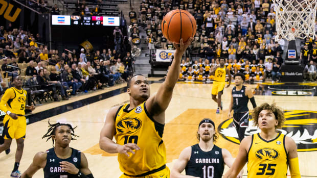 Feb 7, 2023; Columbia, Missouri, USA; Missouri Tigers guard Nick Honor (10) shoots a layup as South Carolina Gamecocks guard Meechie Johnson (5) and forward Hayden Brown (10) defend during the second half at Mizzou Arena. Mandatory Credit: Jay Biggerstaff-USA TODAY Sports
